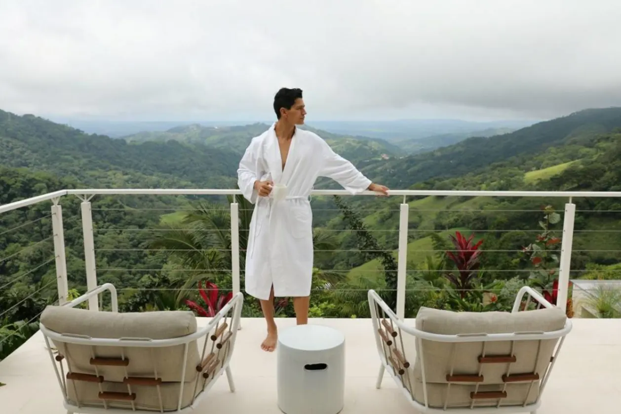 Man on balcony wearing bathrobe at The Retreat Costa Rica
